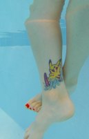 I love this surfing Pikachu tattoo. I hate that the toes got cut off in the photo though.
